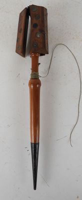 a wooden object with a metal object attached to it