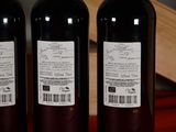 three bottles of wine sitting next to each other on a table