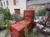 a pile of red boxes sitting in front of a building