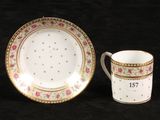 two cups and a saucer are sitting next to each other