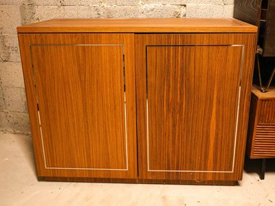 a wooden cabinet with two doors and a television on it