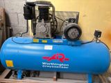 a blue air compressor sitting on top of a pallet