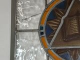 a picture of a stained glass window with a book on it
