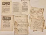 several old papers are sitting on top of a table