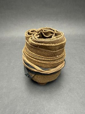 a roll of jute rope on a gray surface