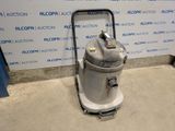 the vacuum is sitting on the floor in front of the wall