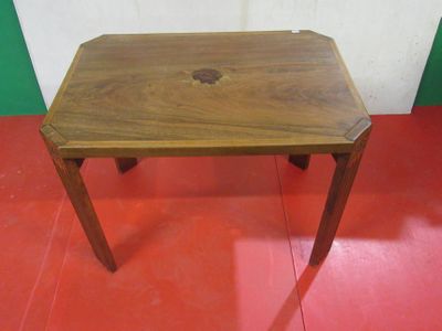 a small wooden table with a hole in the top