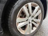 a close up of a car ' s tire on the road