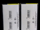 two boxes with labels on them on a black background