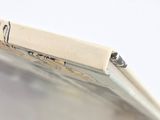 a close up of a cell phone on a white surface