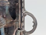 a silver tray with a silver tea pot and a silver teapot