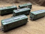 four green trains sitting on the ground next to each other