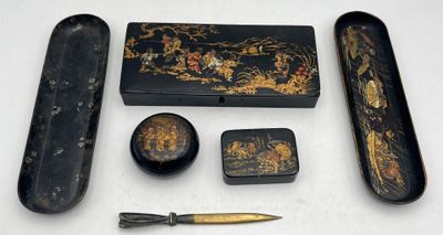 a black and gold box with a pen, scissors, and other items