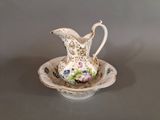a white pitcher and a bowl on a table