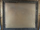 an old wooden frame with a black border and a brown background