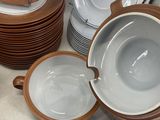 many plates and bowls that are sitting on a table