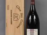 the bottle of wine is sitting next to the wooden box