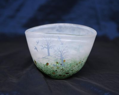 un bol blanc orné d'un motif vert et bleu