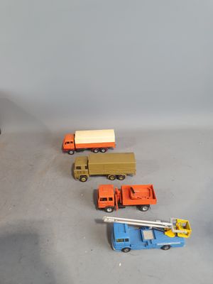 several toy trucks are lined up on a table next to each other