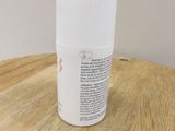 a bottle of deodorant sitting on a wooden table