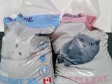 two bags of cat litter sitting on a table