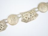 an image of a silver bracelet with four different designs on it