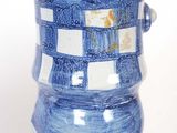 a blue and white vase sitting on top of a table