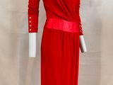 the dress is red and has long sleeves and a belt