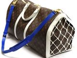 a brown and white handbag with a blue strap