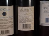three bottles of wine are lined up on a shelf