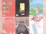 many books that are sitting on a table together