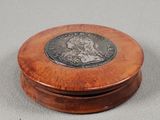 two small wooden boxes with a silver coin on top of them