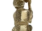 a statue of a man with a basket on top of it