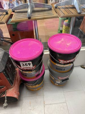 three buckets of paint sitting on the floor next to each other