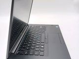 a laptop with a black keyboard sitting on a white surface