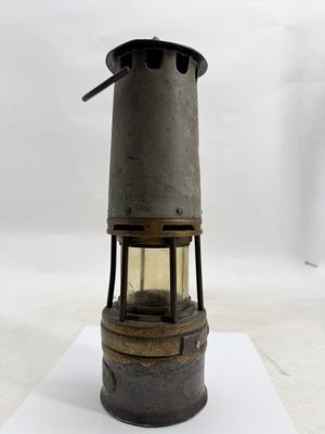an old fashioned oil lamp on a white surface with a white background
