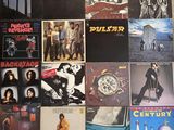 many different album covers on the wall of a room