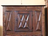 a wooden cabinet with a door and a mirror on it