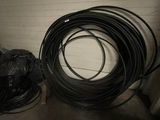 a pile of wires and a hose on the floor