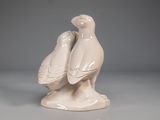 two birds that are sitting next to each other on a table