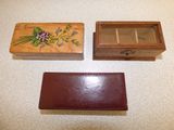 two wooden boxes with flowers on them sitting on a table