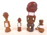 three wooden figurines are sitting next to each other on a white surface