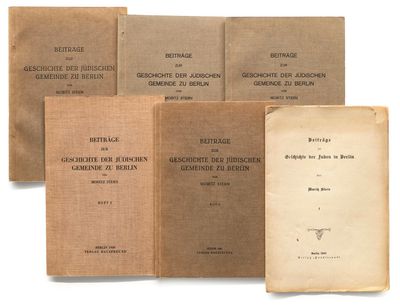 three old books sitting on top of each other on a white surface