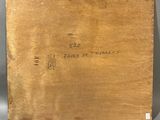 an old book with a brown cover sitting on top of a table