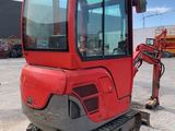 an image of a red construction vehicle parked in a parking lot