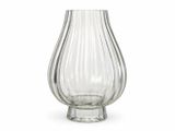 a glass vase that is sitting on a white surface