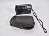 a black camera and a black purse on a white table
