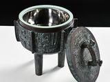 a metal bowl with a lid sitting on a table