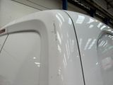 a close up of a white car in a garage
