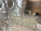 bottles and glasses on a glass shelf in a store